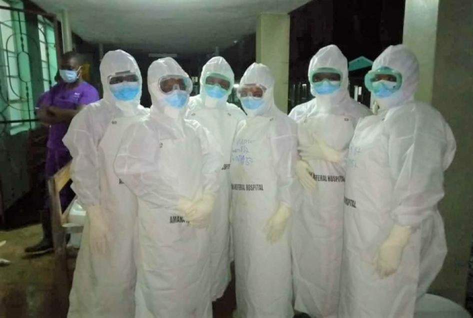 Healthcare workers in full PPE at an African hospital during the COVID-19 pandemic, highlighting the critical role and challenges in medical supply procurement